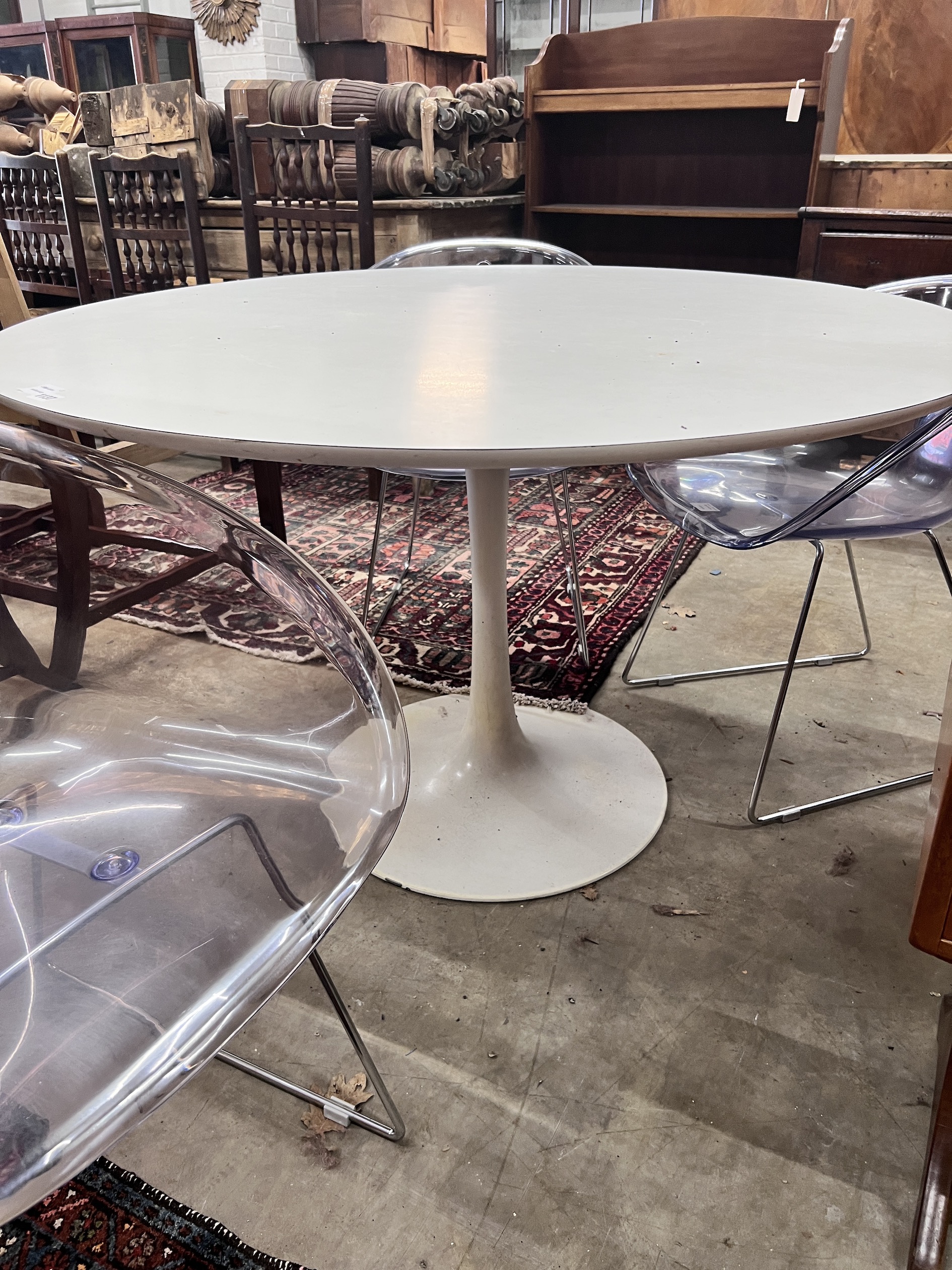 Three Habitat perspex armchairs and a Habitat ‘’Chelsea’’ circular white laminated wood table, diameter 120cm, height 72cm (3)